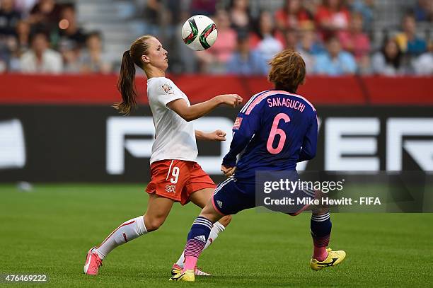 Lia Waelti of Switzerland controls the ball under pressure from Mizuho Sakaguchi of Japan during the FIFA Women's World Cup 2015 Group C match...