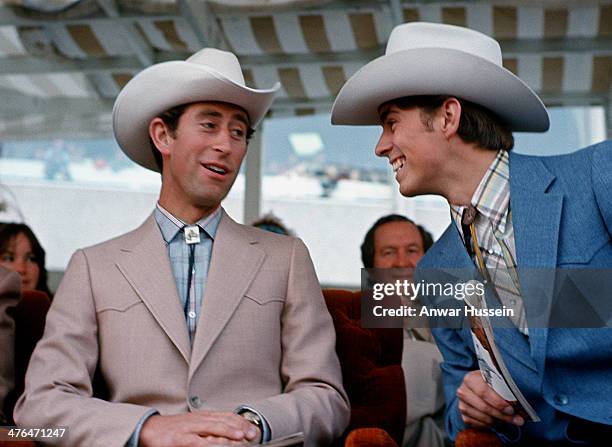 Prince Charles, Prince of Wales and his brother Prince Andrew dress as cowboys as they watch the Calgary Stampede on March 1, 1977 in Calgary, Canada.