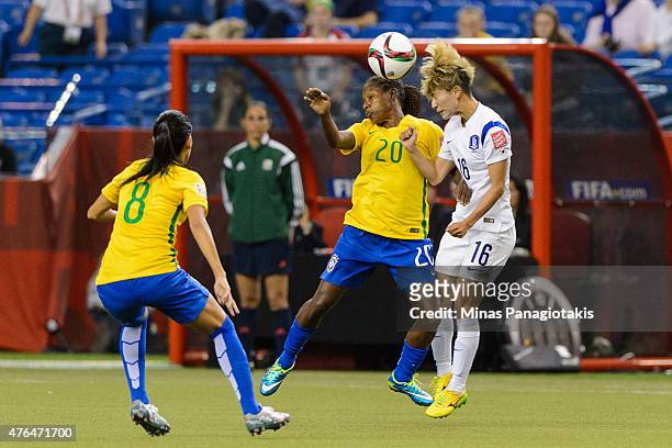 Formiga of Brazil and Kang Yumi of Korea Republic battle for the ball during the 2015 FIFA Women's World Cup Group E match at Olympic Stadium on June...
