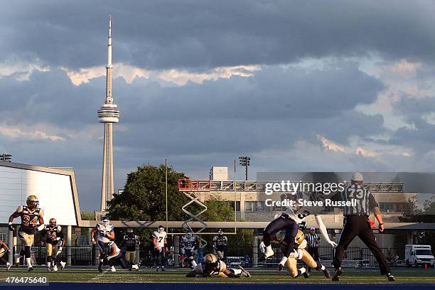 Ontario- JUNE 9 - Toronto Argonauts wide receiver Kevin Elliott is tackled as the Toronto Argonauts play the Winnipeg Blue Bombers as Varsity Stadium...