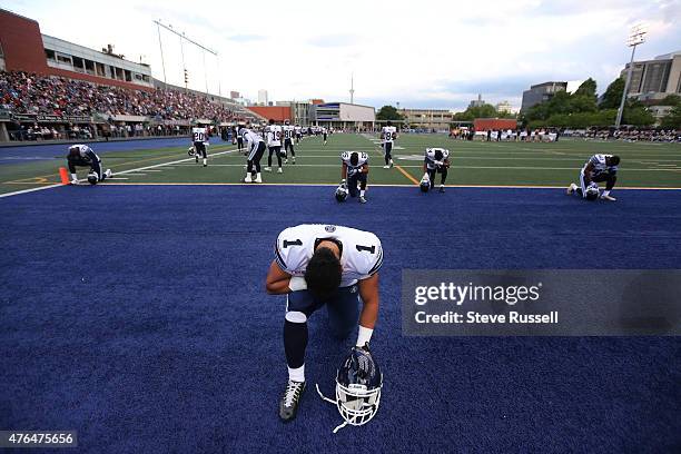 Ontario- JUNE 9 - Toronto Argonauts running back Anthony Coombs kneels for a prayer before the game as the Toronto Argonauts play the Winnipeg Blue...