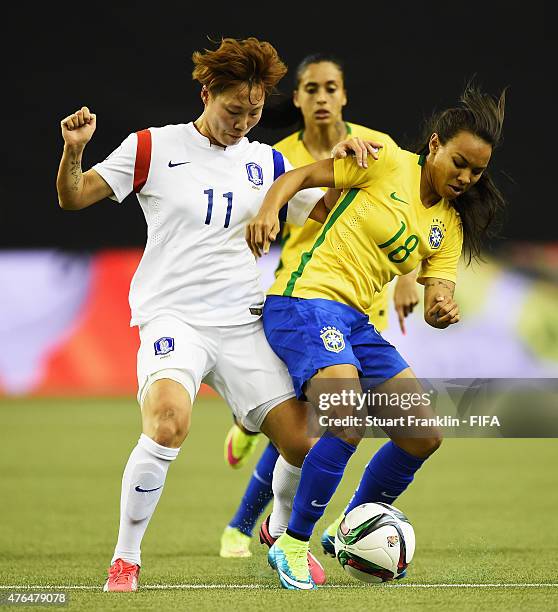 Raquel Fernandez of Brazil is challenged by Seolbin Jung of Korea during the FIFA Women's World Cup 2015 group E match between Brazil and Korea...