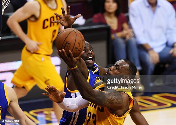 LeBron James of the Cleveland Cavaliers goes up against Festus Ezeli of the Golden State Warriors in the second quarter during Game Three of the 2015...