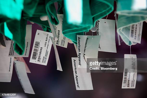 Price tags hang from clothing displayed for sale inside an American Apparel Inc. Store in New York, U.S., on Friday, Feb. 28, 2014. American Apparel...