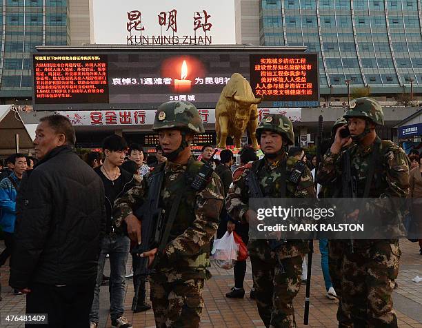 Chinese paramilitary police patrol outside the scene of the attack at the main train station in Kunming, Yunnan Province, on March 3, 2014....