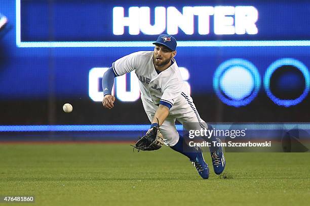 Kevin Pillar of the Toronto Blue Jays dives but cannot come up with the ball that went for a single off the bat of Dee Gordon of the Miami Marlins in...