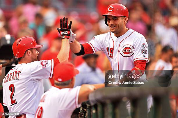 Joey Votto of the Cincinnati Reds celebrates his fifth inning solo home run against the Philadelphia Phillies with Zack Cozart of the Cincinnati Reds...