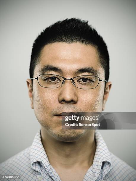 portrait of a young japanese man looking at camera - blank expression stock pictures, royalty-free photos & images