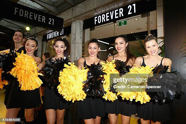 Cheerleaders pose at the opening of the 'FOREVER 21' flagship store on Pitt Street on June 10, 2015 in Sydney, Australia.