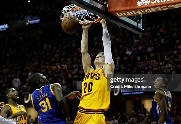 Timofey Mozgov of the Cleveland Cavaliers dunks against Festus Ezeli of the Golden State Warriors in the third quarter during Game Three of the 2015...