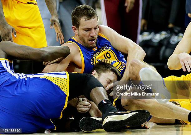 David Lee of the Golden State Warriors fouls Matthew Dellavedova of the Cleveland Cavaliers as they vie for posession in the fourth quarter during...