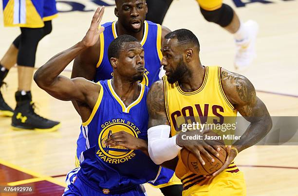 LeBron James of the Cleveland Cavaliers drives against Harrison Barnes of the Golden State Warriors in the first half during Game Three of the 2015...