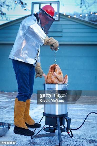 deep frying turkey in hot oil for christmas and thanksgiving - fritterad bildbanksfoton och bilder