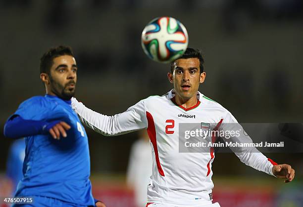 Hussain Fadhel of Kuwait and Bakhtiar Rahmani of Iran in action during the AFC Asian Cup Qualifier between Iran and Kuwait on March 3, 2014 in...