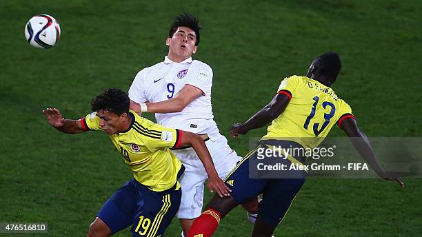 Rubio Rubin of USA jumps for a header with Victor Gutierrez and Davinson Sanchez of Colombia during the FIFA U-20 World Cup New Zealand 2015 Round of...