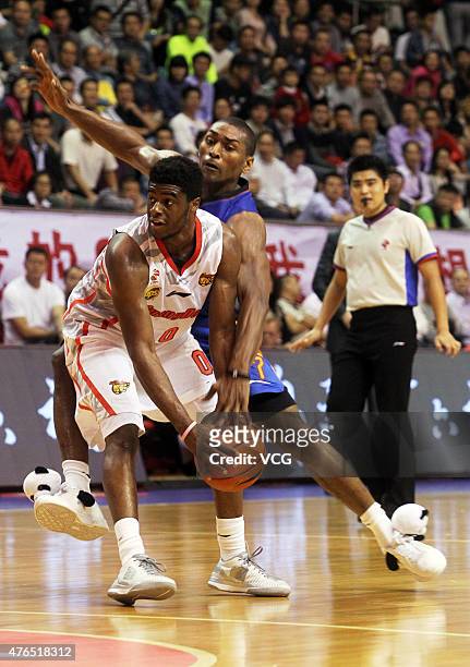 Emmanuel Mudiay of Guangdong Southern Tigers competes against Metta World Peace of Sichuan Jinqiang during the CBA 14/15 game on November 1, 2014 in...