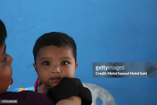 Muslim Rohingya children smile during a day of commemoration to remember the 2012 Rohingya genocide on June 10, 2015 in Serdang, Malaysia. Malaysia's...
