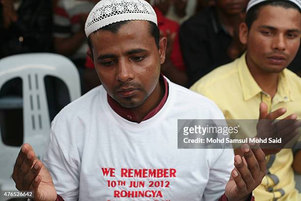 Muslim Rohingyas living in Malaysia perform a prayer during a day of commemoration to remember the 2012 Rohingya genocide on June 10, 2015 in...