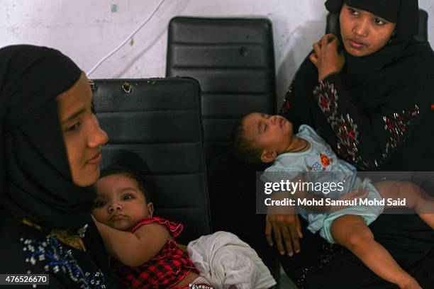 Muslim womens Rohingyas living in Malaysia is seen with her baby's inside the hall during a day of commemoration to remember the 2012 Rohingya...