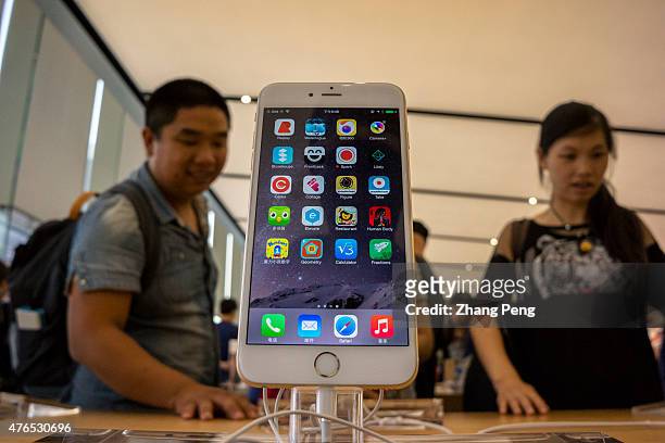 Chinese customers are experiencing and choosing Apple's products in an Apple store beside West lake in Hangzhou, which is the biggest Apple store in...