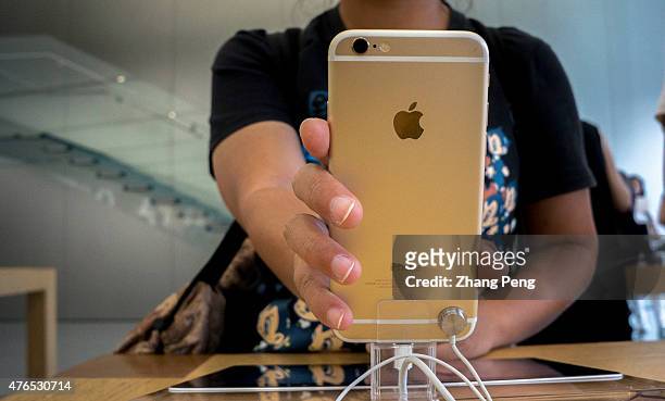 Chinese customers are experiencing and choosing Apple's products in an Apple store beside West lake in Hangzhou, which is the biggest Apple store in...