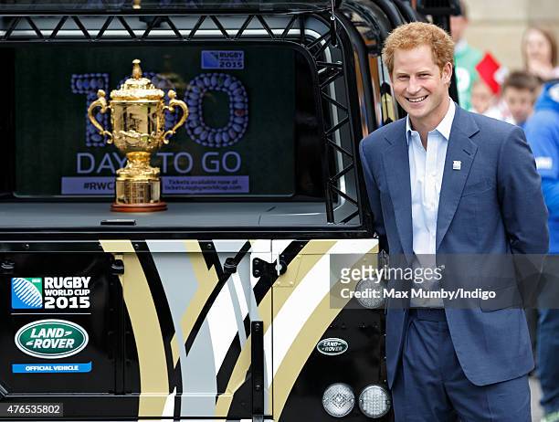 Prince Harry stands alongside the Webb Ellis Cup as he attends the launch of the Rugby World Cup Trophy Tour, 100 days before the Rugby World Cup at...