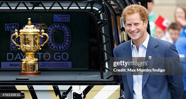 Prince Harry stands alongside the Webb Ellis Cup as he attends the launch of the Rugby World Cup Trophy Tour, 100 days before the Rugby World Cup at...