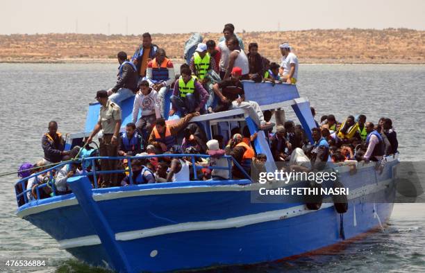 Migrants arrive at the port in the Tunisian town of Ben Guerdane, some 40 kilometres west of the Libyan border, following their rescue by Tunisia's...