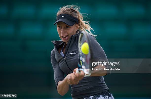 Magda Linette of Poland returns a shot during her match against Lauren Davis on day three of the WTA Aegon Open Nottingham at Nottingham Tennis...