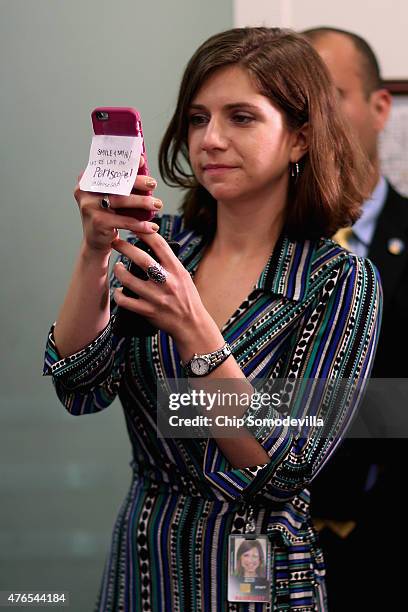 House Republican staffer holds an iPhone with the message 'Smile and say hi! We're live on Periscope! @HouseGOP' during a news conference following...