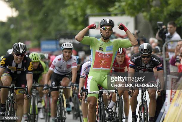France's Nacer Bouhanni, wearing the best sprinter's green jersey, celebrates as he crosses the finish line at the end of the 228 km fourth stage of...