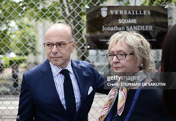 French Interior Minister Bernard Cazeneuve and the mother of Jonathan Sandler, one of the individuals killed by Islamist gunman Mohamed Merah in...