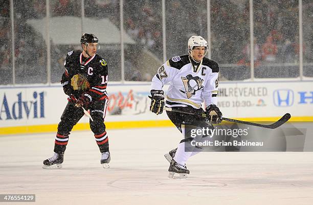 Jonathan Toews of the Chicago Blackhawks and Sidney Crosby of the Pittsburgh Penguins skate through the neutral zone during the 2014 NHL Stadium...