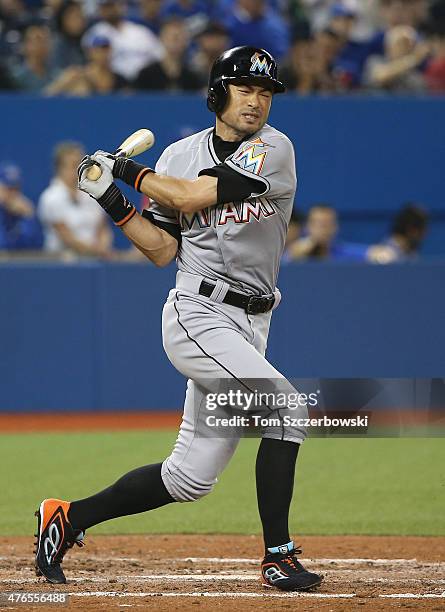 Ichiro Suzuki of the Miami Marlins reacts as he hits a foul ball off his foot in the fifth inning during MLB game action against the Toronto Blue...