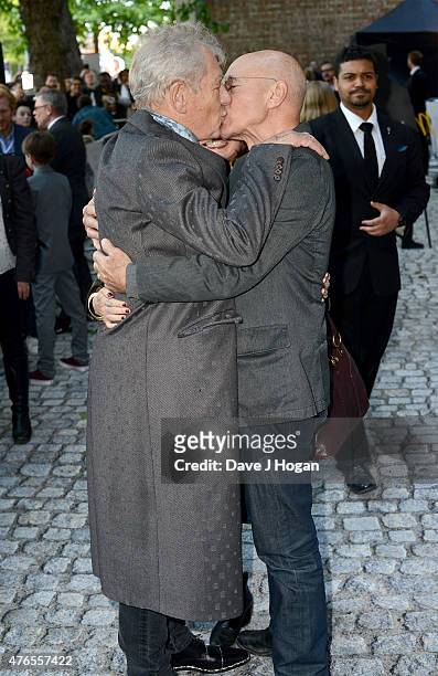 Actors Sir Ian McKellen and Patrick Stewart kiss as they attend the UK Premiere of "Mr Holmes" at the Odeon Kensington on June 10, 2015 in London,...
