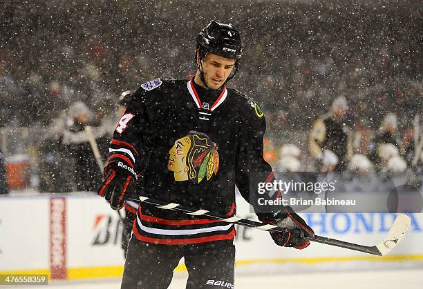 Niklas Hjalmarsson of the Chicago Blackhawks looks on during the 2014 NHL Stadium Series game against the Pittsburgh Penguins at Soldier Field on...