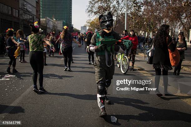 Protesters and students march to protest against the government and police action that injured a fellow student last mont in Santiago, one of the...