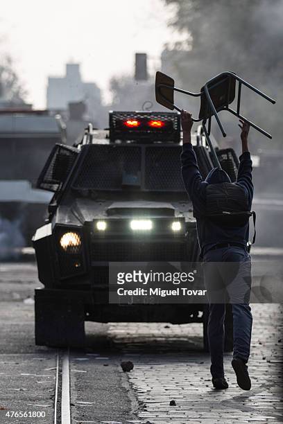 Masked protester clashes with police before a march to protest against the government and police action that injured a fellow student last mont in...