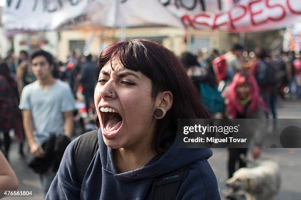 Student shouts slogans during a protest against the government and police action that injured a fellow student last mont in Santiago, one of the host...