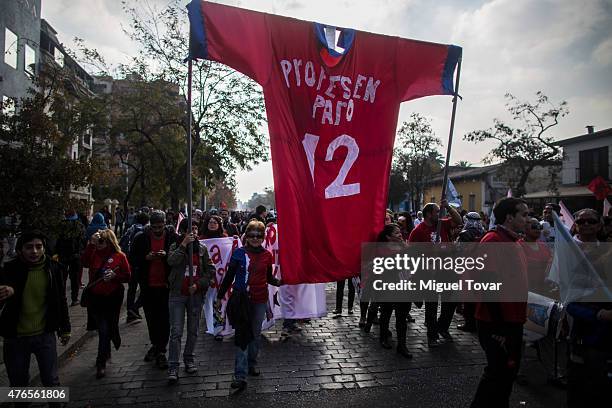 Profesors and students march to protest against the government and police action that injured a fellow student last mont in Santiago, one of the host...