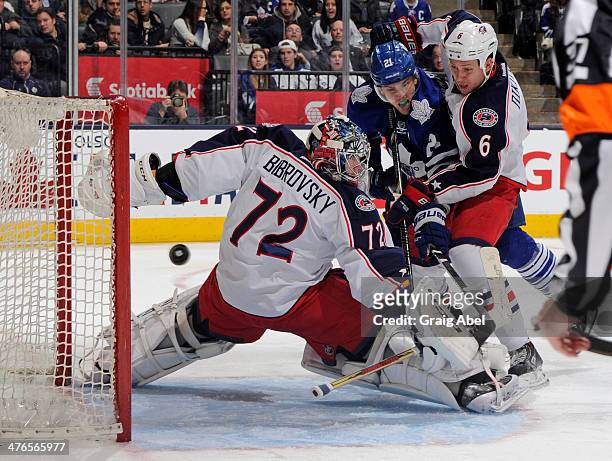 Sergei Bobrovsky of the Columbus Blue Jackets defends the goal as teammate Nikita Nikitin battles with James van Riemsdyk of the Toronto Maple Leafs...