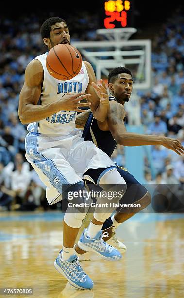 James Michael McAdoo of the North Carolina Tar Heels battles Eric Atkins of the Notre Dame Fighting Irish for the ball during a game at the Dean...