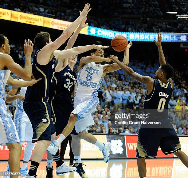 Pat Connaughton, Steve Vasturia and Eric Atkins of the Notre Dame Fighting Irish defend a drive by Marcus Paige of the North Carolina Tar Heels...