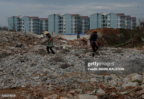 This photo taken on on February 20, 2014 shows the construction of new high-rise apartments that will house villagers near the city of Anshun,...
