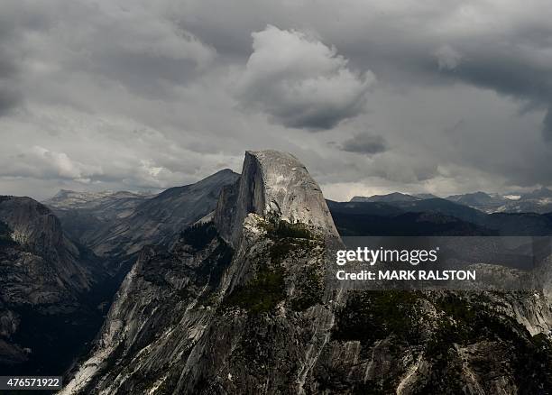 Vew of the Half Dome monolith from Glacier Point at the Yosemite National Park in California on June 4, 2015. At first glance the spectacular beauty...