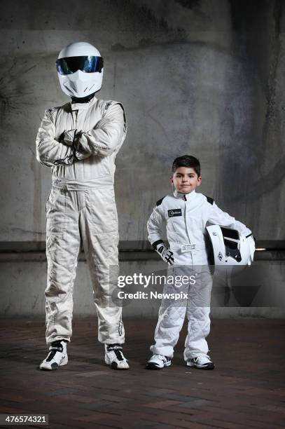 Year-old Anthony Hayek poses with racing driver 'The Stig' from the television show 'Top Gear' during a photo shoot on February 28, 2014 in Sydney,...