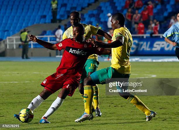 Alejandro Peñaranda of America de Cali struggles for the ball with Germán Meraof Bucaramanga during a match between America de Cali and Bucaramanga...