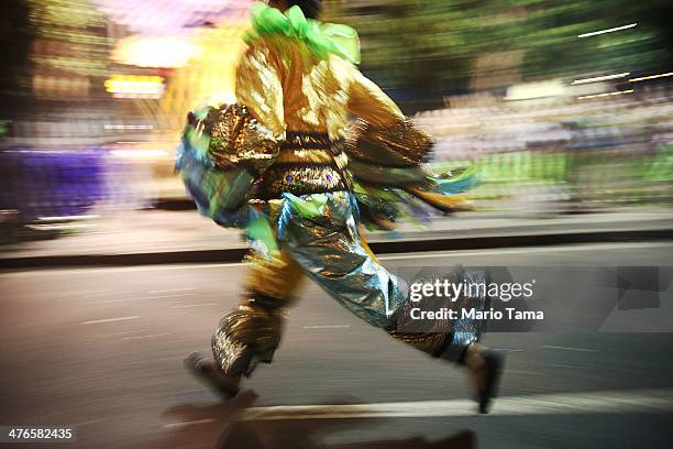 Performer runs before the start of the Portela samba school parade at 2014 Brazilian Carnival at Sapucai Sambadrome on March 03, 2014 in Rio de...