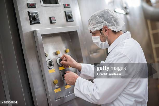 man operating machine at a food factory - switchboard operator stock pictures, royalty-free photos & images