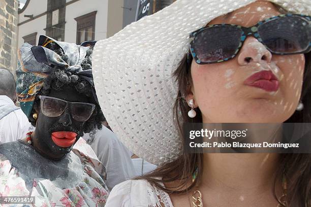 Revellers look on during Los Indianos carnival on March 3, 2014 in Santa Cruz de La Palma, Spain. The origin of the 'Dia de los Indianos' carnival is...